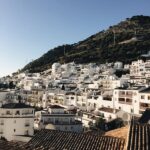 White buildings on hillside under blue sky